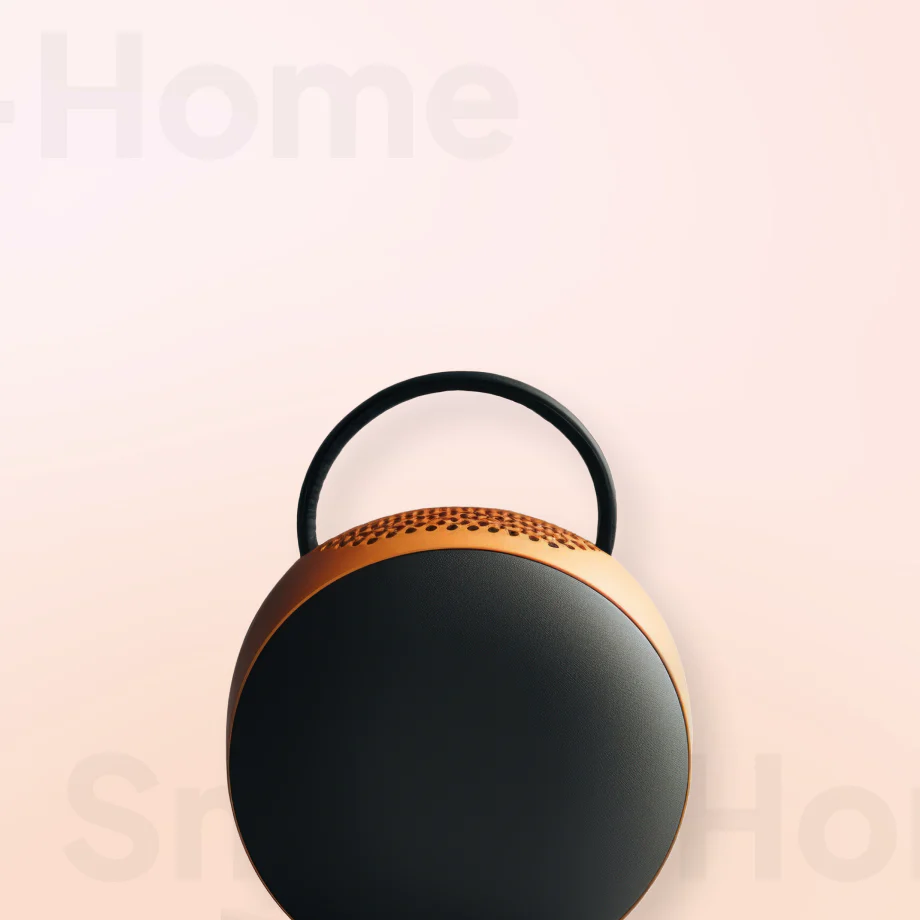 Modern black and copper lamp with 'Home' text in the background