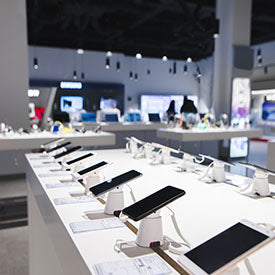 Row of electronic devices on display in a store setting